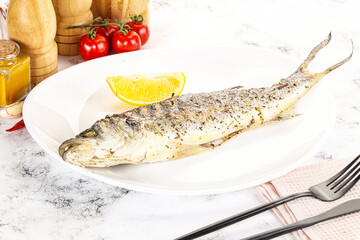 Grilled sea bass fish served lemon