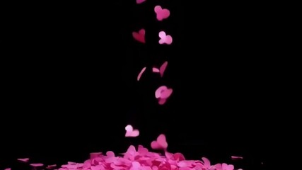 A cascade of pink heart shapes falling gently against a black background, evoking romance and joy in a visually rich, elegant manner - Powered by Adobe