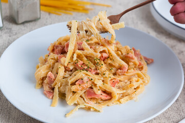 homemade fettuccine pasta with white cream sauce. fettuccine Carbonara, Italian food. Perfect for recipes, articles or any cooking content.