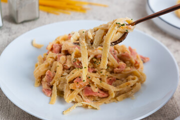 homemade fettuccine pasta with white cream sauce. fettuccine Carbonara, Italian food. Perfect for recipes, articles or any cooking content.