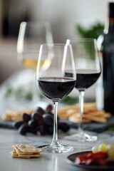Fototapeta premium Red wine glasses on indoor table top.