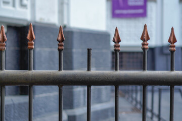 close-up view of a broken spear-shaped iron fence.
