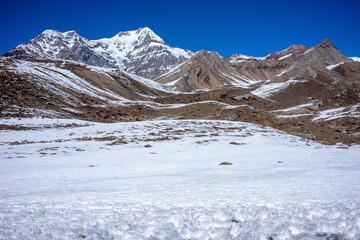 Snow-covered mountain range under a deep blue sky. Perfect for showcasing winter landscapes and adventure travel.