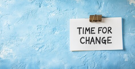 A torn piece of paper clipped on a blue background with the words “TIME FOR CHANGE,” symbolizing transformation and new beginnings.
