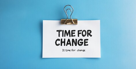 A torn piece of paper clipped on a blue background with the words &ldquo;TIME FOR CHANGE,&rdquo; symbolizing transformation and new beginnings.
