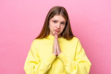 Teenager Russian girl isolated on pink background keeps palm together. Person asks for something