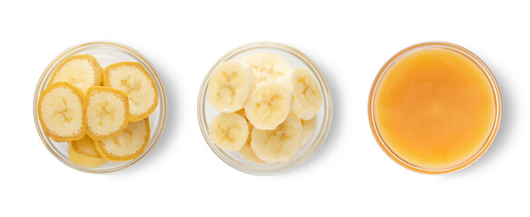 Raw ripe yelow banana slices with skin and mashed banana in glass bowls on white background.Top view.Macro.