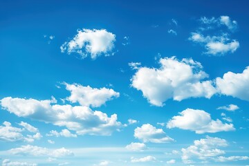 Obraz premium Clear blue sky with white puffy clouds. Serene atmosphere of summer morning. Tropical colors and ultramarine hues create a peaceful natural landscape.