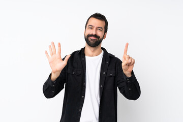 Young man with beard over isolated white background counting six with fingers