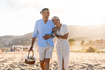 Beautiful happy senior couple dating at the seaside during summertime - Mature married couple in...