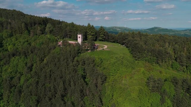 San Mauro di Saline, Italy - 05 05 2024:  Ancient hermitage of San Moro. Aerial shot of the beautiful church on Mount Moro. Romanesque-Gothic construction, monastic community. Lessinia plateau.