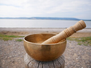 Singing bowl with the pond in background