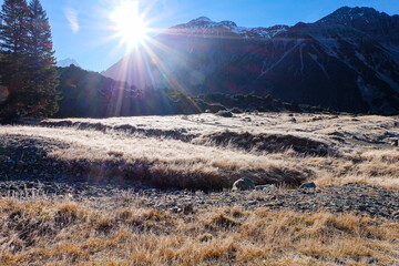 Hiking in a beautiful sunny blue sky winter day at Mount Cook national park, South Island New...