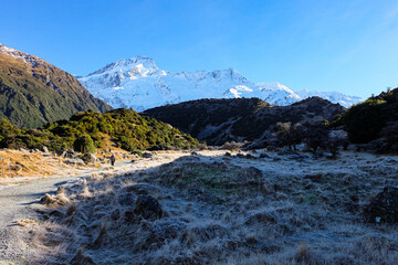 Hiking in a beautiful sunny blue sky winter day at Mount Cook national park, South Island New Zealand