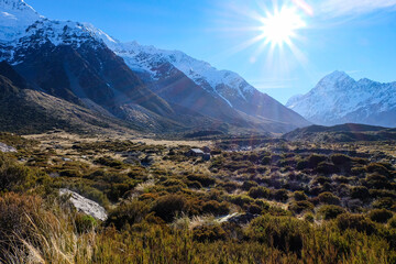 Hiking in a beautiful sunny blue sky winter day at Mount Cook national park,  South Island New...