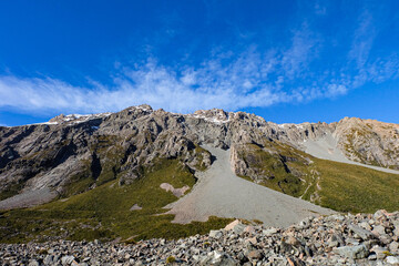Hiking in a beautiful sunny blue sky winter day at Mount Cook national park,  South Island New Zealand 