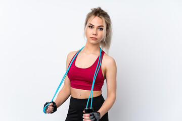 Teenager girl holding waffles over isolated blue background with jumping rope