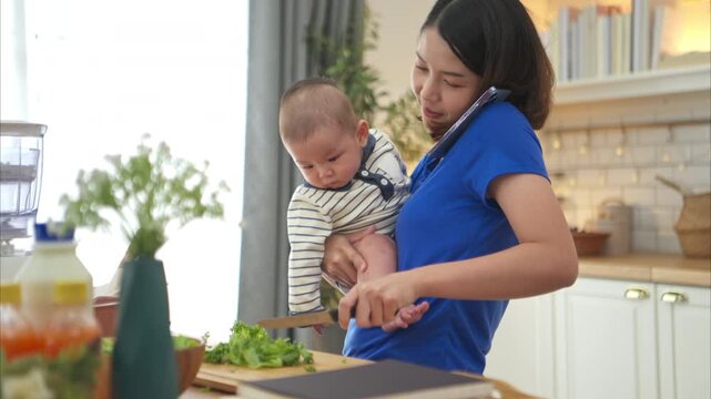 Mother and tiny child in the kitchen preparing dinner