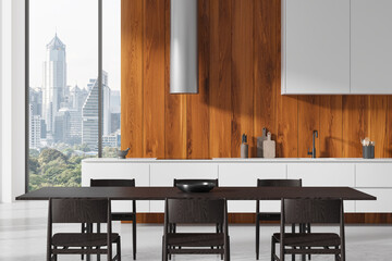 Home kitchen interior with cooking cabinet, dining table and panoramic window