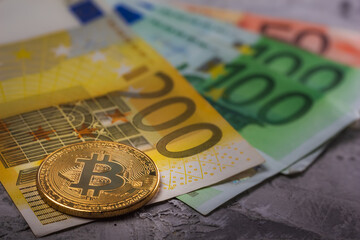A Bitcoin on Euro banknotes symbolizes the contrast between cryptocurrency and traditional currency