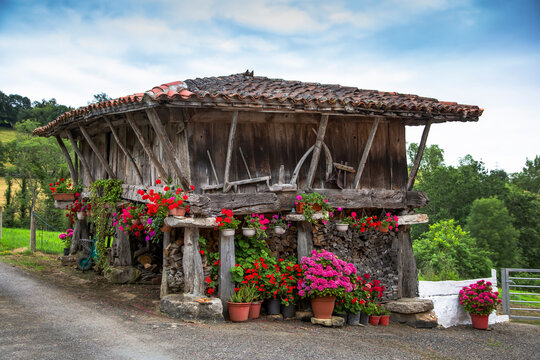 Typical Asturian granary called "horreo" decorated with flowers.