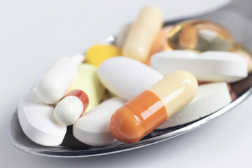 Macro photo of Medicinal Medicines stacked in a metal spoon. Stock photo.