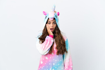 Young caucasian woman wearing a unicorn pajama isolated on white background with surprise and shocked facial expression