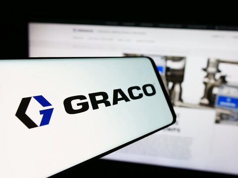 Stuttgart, Germany - 07-24-2024: Smartphone with logo of American fluid-handling equipment company Graco Inc. in front of business website. Focus on center-left of phone display.