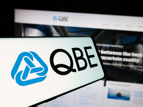 Stuttgart, Germany - 07-25-2024: Smartphone with logo of Australian company QBE Insurance Group Limited in front of business website. Focus on center of phone display.