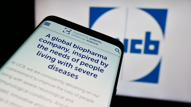 Stuttgart, Germany - 07-25-2024: Mobile phone with website of Belgian biopharmaceutical company UCB S.A. in front of business logo. Focus on top-left of phone display.