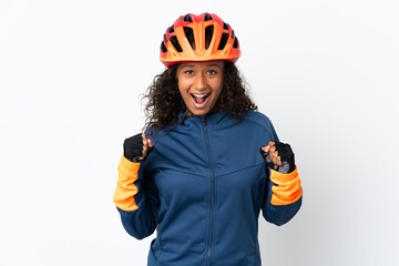 Teenager cyclist woman isolated on white background celebrating a victory in winner position