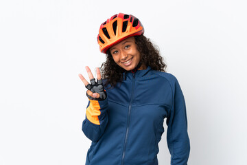Teenager cyclist woman isolated on white background happy and counting three with fingers