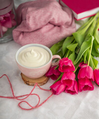 white cup of coffee with violet tulips