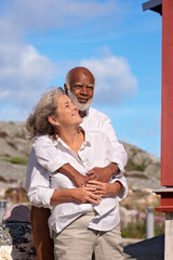 A loving couple embraces in a scenic outdoor setting, reflecting their deep connection