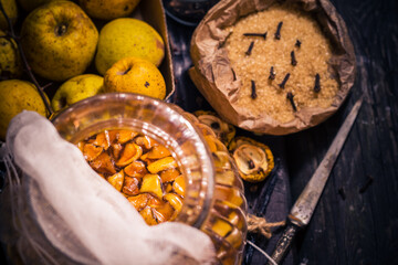 Ingredients tinctures Fruits twigs quince sugar cloves vanilla wooden table