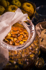 Ingredients tinctures Fruits twigs quince sugar cloves vanilla wooden table