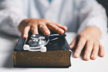 Doctor clasped their hands in prayer, hoping for the best as they provided medical care in hospital...