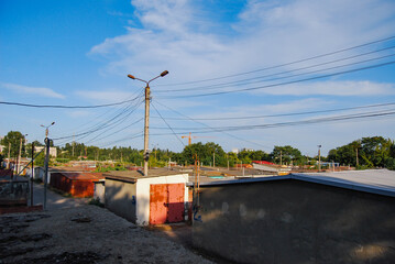Panorama of the garage complex from above.
The large area is covered with numerous car garages and a number of electric poles. A construction crane can be seen in the background.