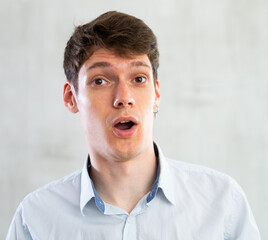 Emotions, people and positive concept man expresses different on gray background