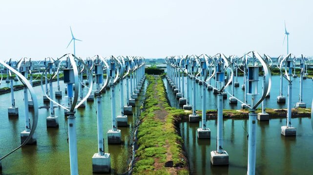 Drone aerial shot of large white vertical axis wind turbine power plant wide angle and close-up, green energy