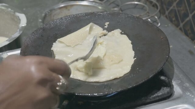 Patishapta Pitha, a famous Bengali Dessert Recipe, being prepared during Winter season. Patishapta is a type of pithe made in celebratory occasions, quick Indian dessert. Howrah, West Bengal, India
