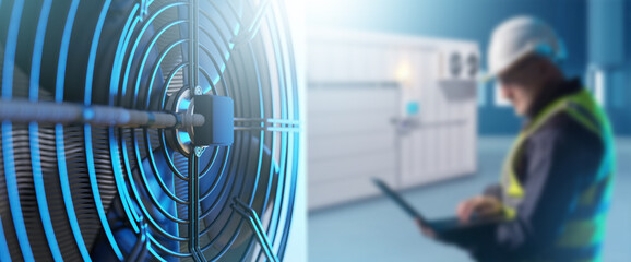 Industrial refrigeration equipment. Air conditioning unit for freezer warehouse. Man with laptop is...