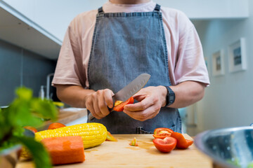 Chef at the kitchen preparing spicy glass noodle salad