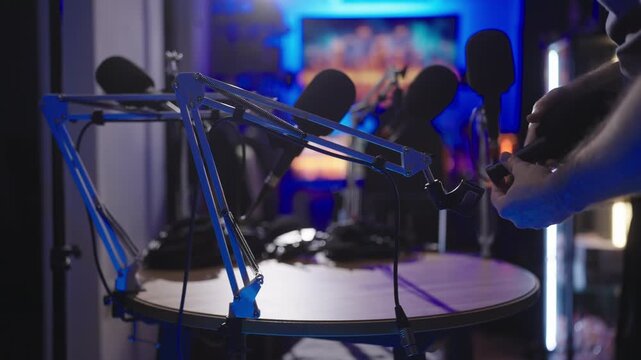 Setting up podcast set with microphone on table arm 4K