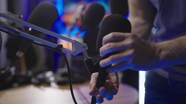 Removing podcast microphone from table arm close-up 4K