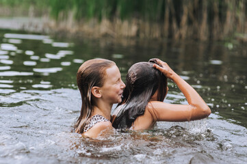 Two girlfriends, smiling happy children swimming in water, diving in lake, fishing in sea, playing on summer holidays. Photography, portrait, childhood concept.