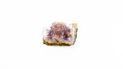 A purple crystal amethyst stone on a white background