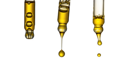 Dripping cosmetic serum from pipettes on white background