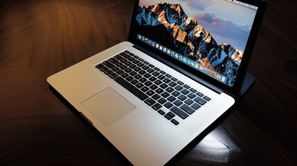 Laptop on dark polished surface with soft spotlight