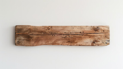 A rustic, reclaimed wooden plank is affixed to a plain white wall, highlighting its natural texture and weathered character.